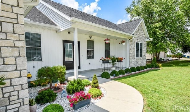 doorway to property with a yard and covered porch