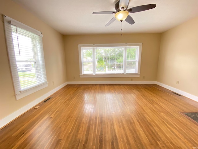 spare room with hardwood / wood-style flooring and ceiling fan