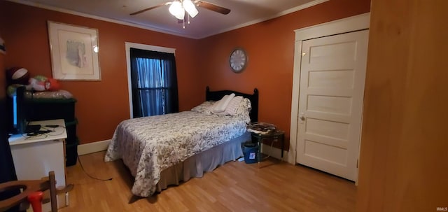 bedroom with ceiling fan, wood-type flooring, and crown molding