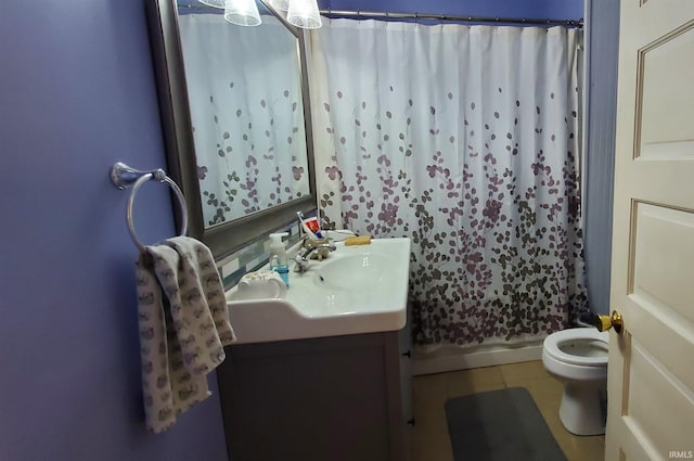 bathroom featuring toilet, tile patterned flooring, vanity, and curtained shower