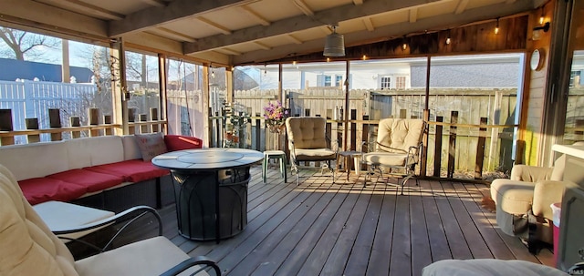 sunroom featuring lofted ceiling with beams