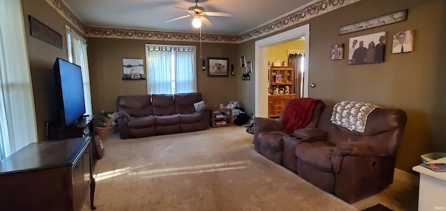 carpeted living room with ceiling fan