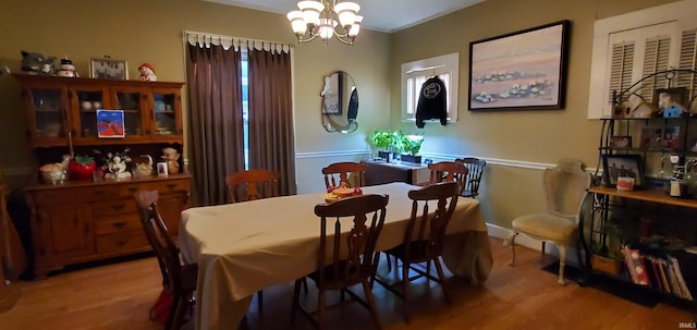 dining space with an inviting chandelier and hardwood / wood-style flooring