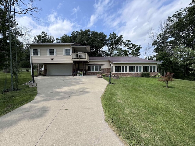 view of front of home with a garage, a balcony, and a front yard