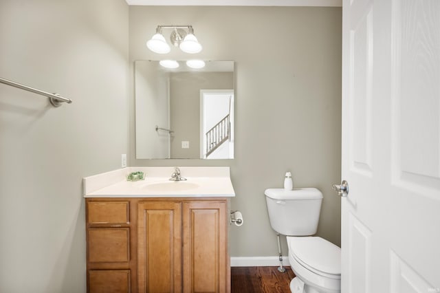 bathroom featuring hardwood / wood-style floors, toilet, and vanity