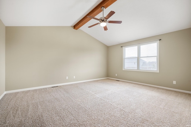 carpeted spare room with ceiling fan and vaulted ceiling with beams