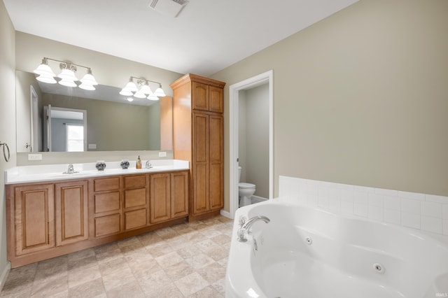 bathroom with tiled bath, toilet, and vanity