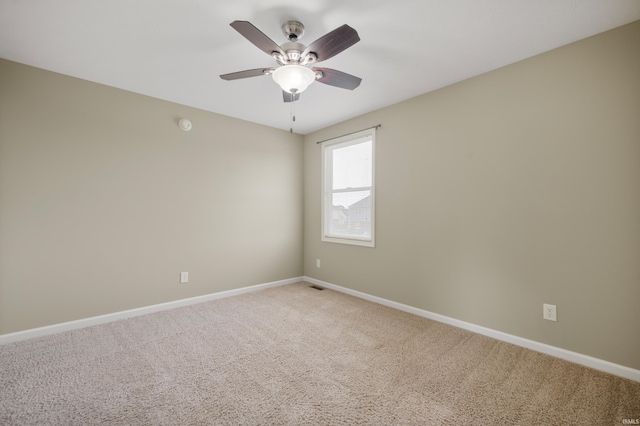 spare room featuring ceiling fan and carpet