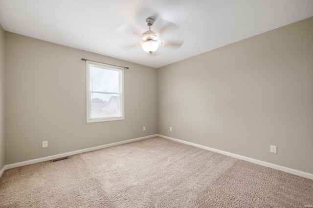 carpeted empty room featuring ceiling fan