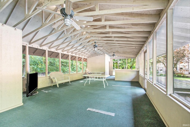 unfurnished sunroom featuring ceiling fan and vaulted ceiling