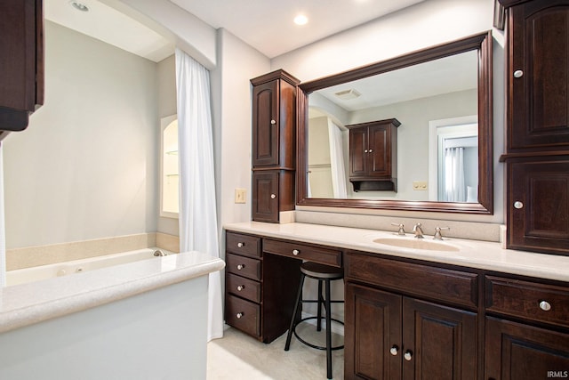 bathroom featuring vanity and a tub