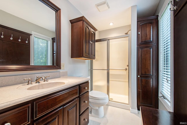 bathroom with vanity, toilet, and walk in shower