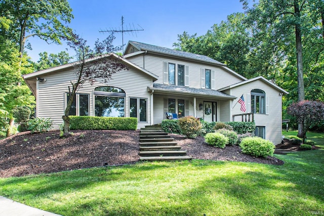 view of property featuring a porch and a front lawn