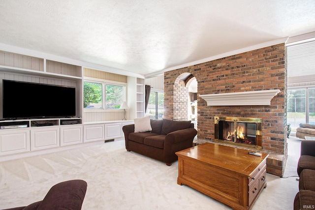 carpeted living room featuring a brick fireplace and a textured ceiling