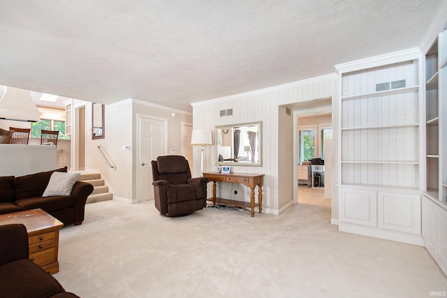 living room with ornamental molding, light carpet, a textured ceiling, and a skylight