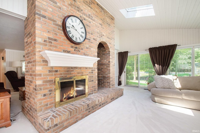 living room featuring lofted ceiling with skylight, a brick fireplace, light carpet, and wooden walls