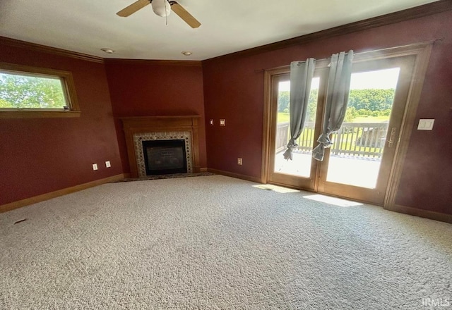 unfurnished living room featuring carpet floors, ceiling fan, and crown molding