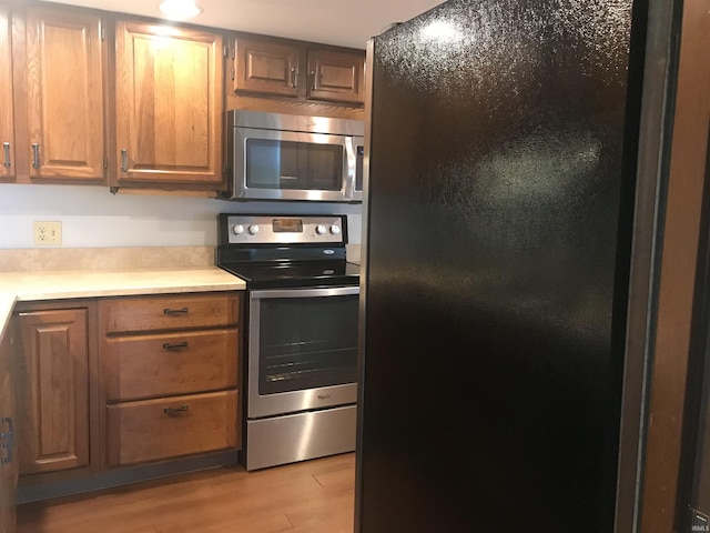 kitchen featuring stainless steel appliances and light hardwood / wood-style floors