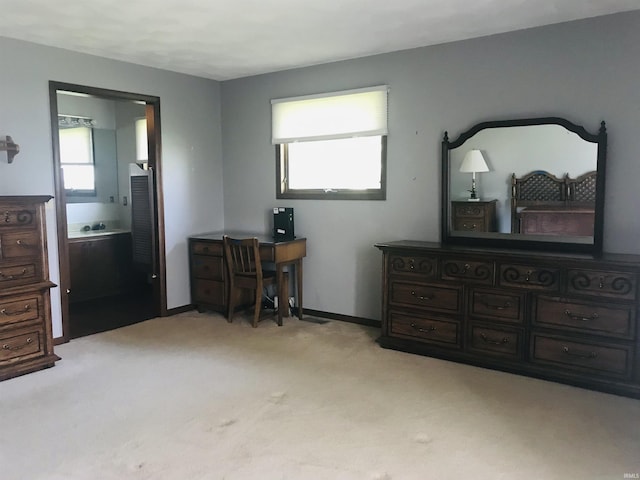 carpeted bedroom featuring multiple windows and ensuite bathroom