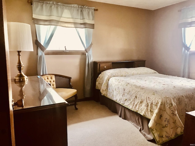 carpeted bedroom featuring multiple windows