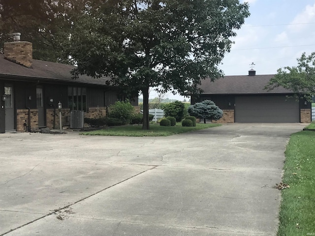 view of front of home with central AC and a garage