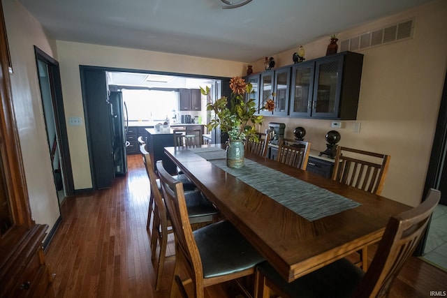 dining space with dark hardwood / wood-style floors