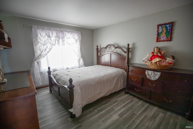 bedroom with dark hardwood / wood-style flooring