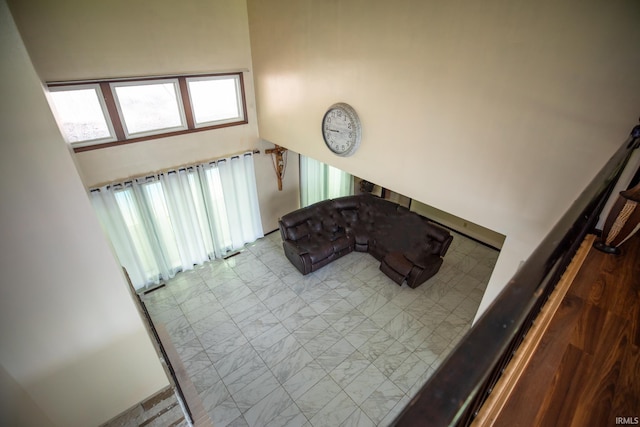 living room featuring tile patterned flooring and a towering ceiling