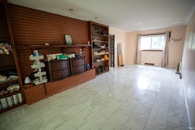 miscellaneous room with brick wall and tile patterned floors