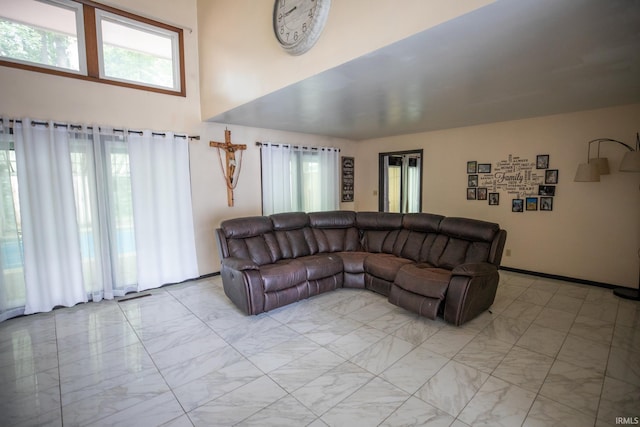 tiled living room with a towering ceiling