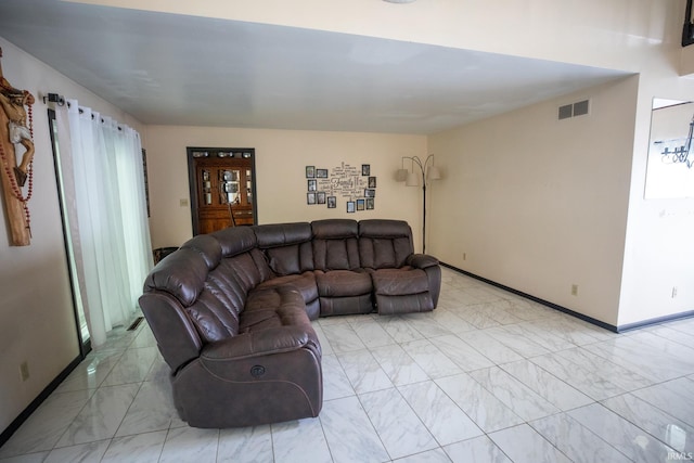 living room with a wealth of natural light and light tile patterned floors