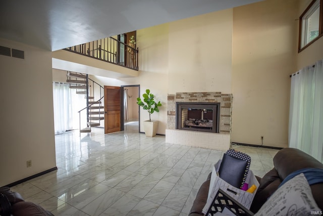 unfurnished living room featuring a high ceiling and tile patterned floors