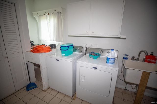 laundry area with cabinets, washer and clothes dryer, and light tile patterned floors