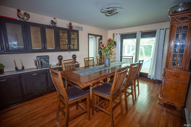 dining room with dark hardwood / wood-style flooring