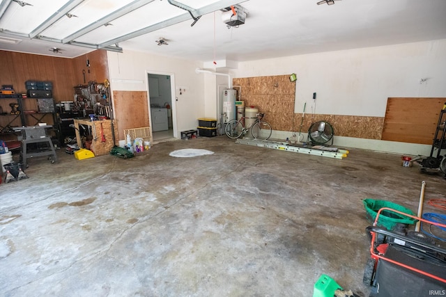 garage featuring washer / dryer, a garage door opener, and water heater