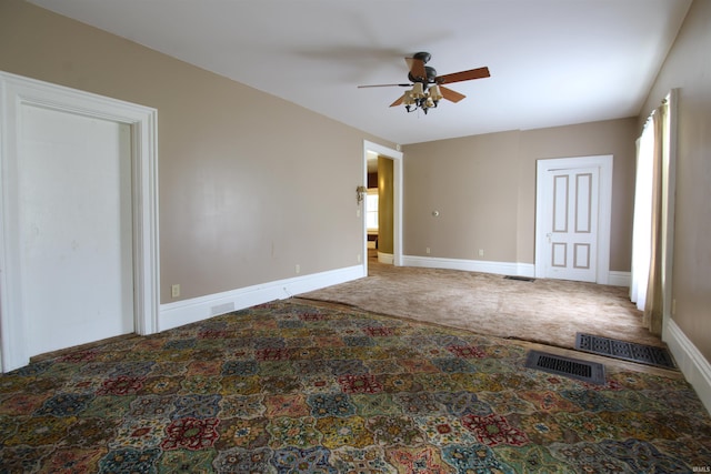 unfurnished room with ceiling fan and carpet