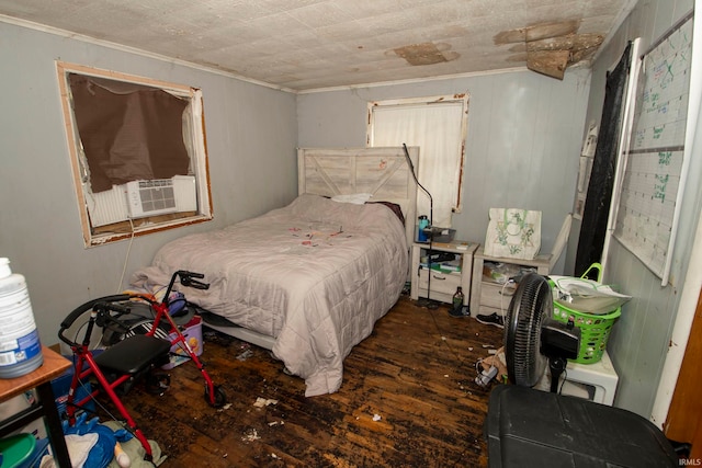 bedroom featuring cooling unit, dark hardwood / wood-style flooring, and ornamental molding