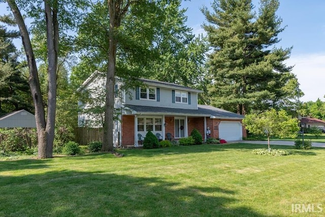 view of front of house with a garage and a front lawn