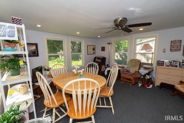 carpeted dining area with ceiling fan