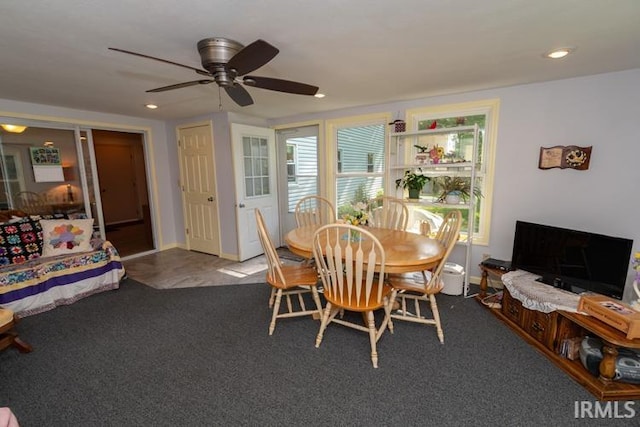 dining space featuring carpet floors and ceiling fan