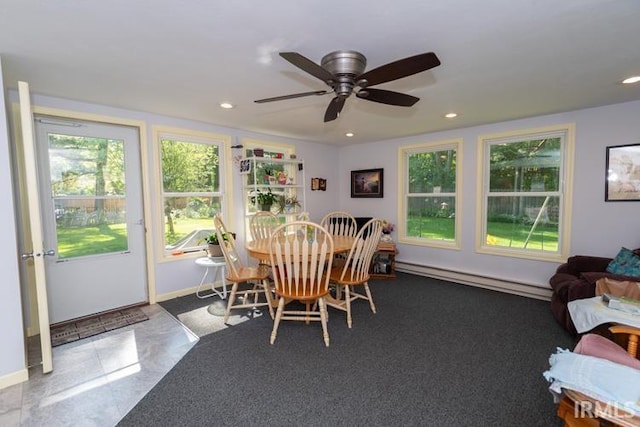 dining area featuring a baseboard heating unit, tile patterned floors, and ceiling fan