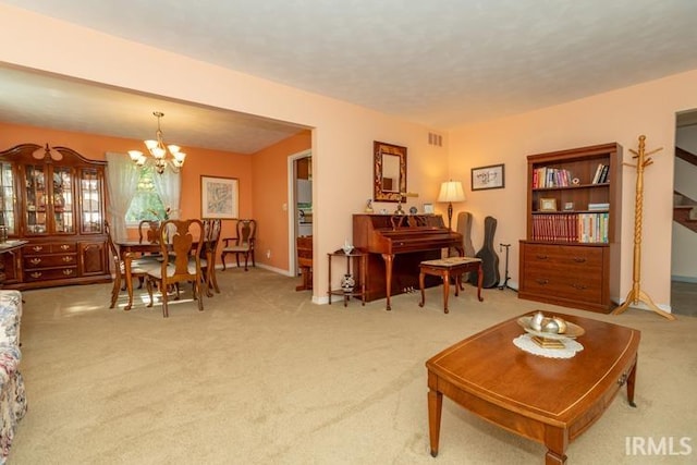 carpeted living room with a chandelier