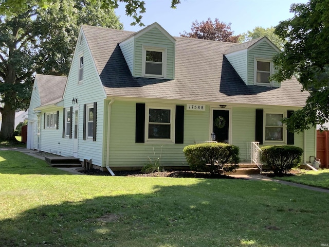 cape cod home with a front lawn