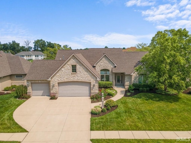 french provincial home featuring a garage and a front lawn