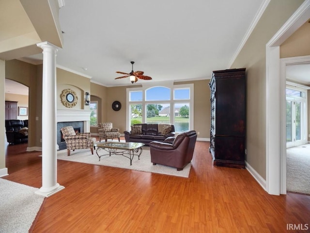 living room with ornamental molding, hardwood / wood-style floors, decorative columns, and ceiling fan