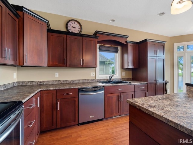 kitchen featuring sink, light hardwood / wood-style flooring, dishwasher, and range