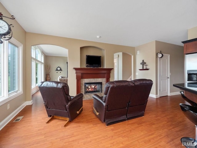 living room with hardwood / wood-style flooring and a fireplace