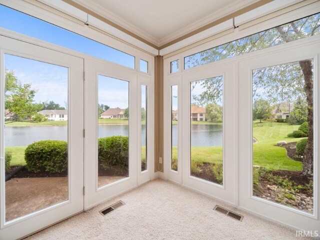 sunroom with plenty of natural light and a water view