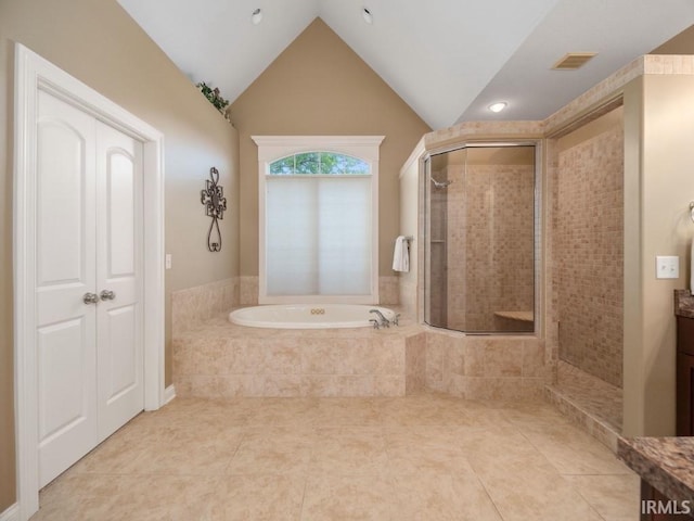 bathroom with vanity, tile patterned floors, and vaulted ceiling