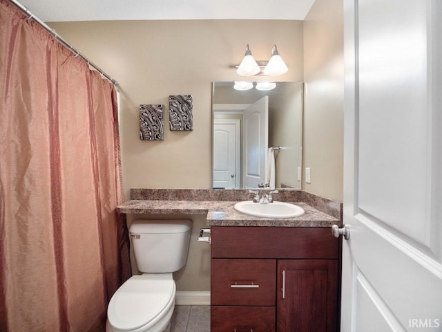 bathroom with tile patterned floors, vanity, and toilet